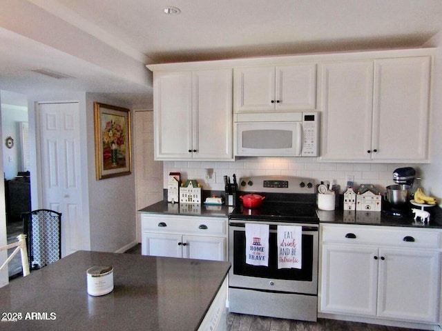 kitchen with tasteful backsplash, stainless steel electric range, and white cabinets