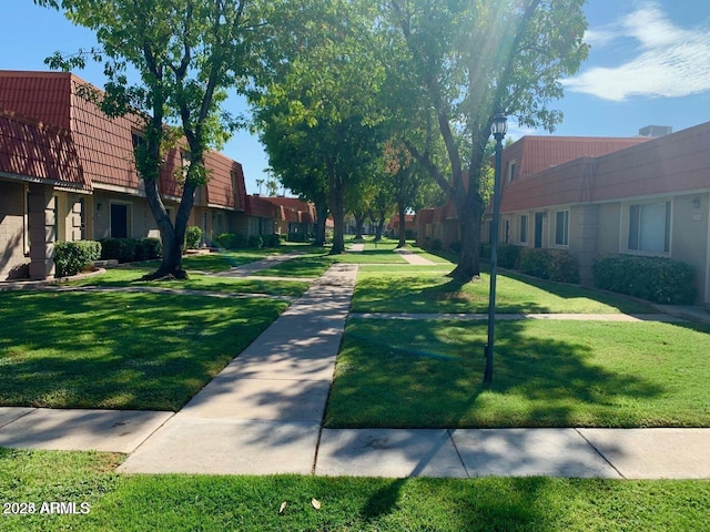 view of property's community with a lawn