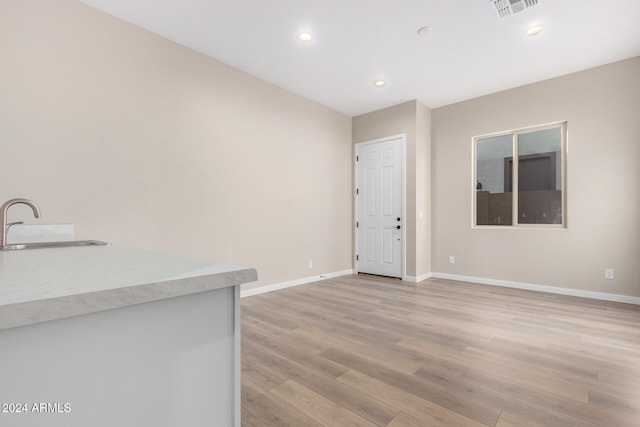 interior space with sink and light wood-type flooring