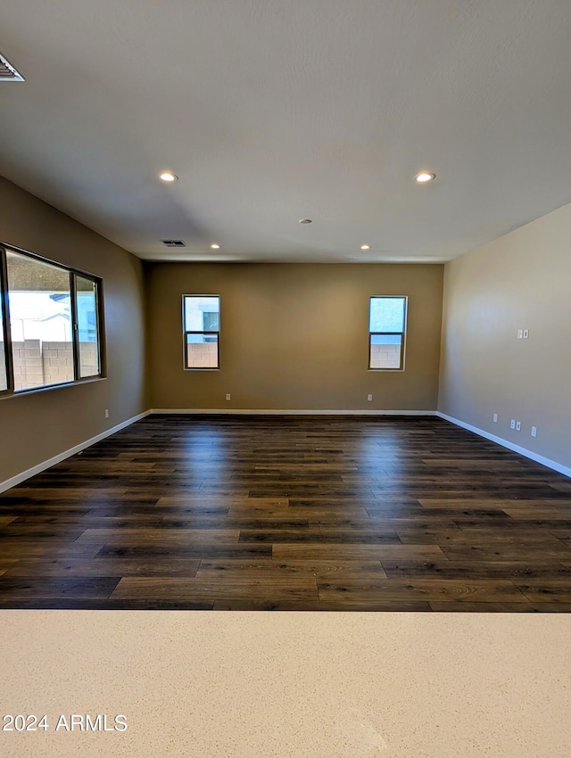 unfurnished room featuring dark wood-type flooring