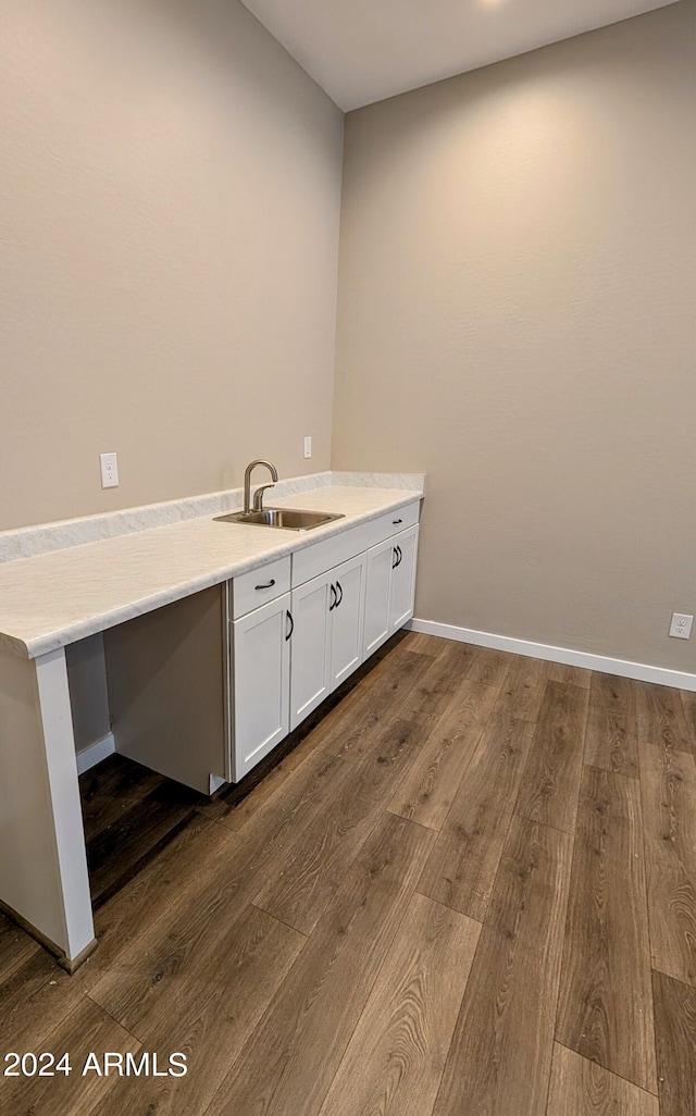 clothes washing area with dark hardwood / wood-style floors and sink