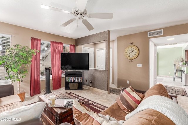 tiled living room with ceiling fan