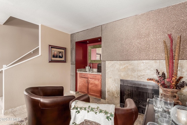 sitting room featuring a fireplace and light tile patterned floors