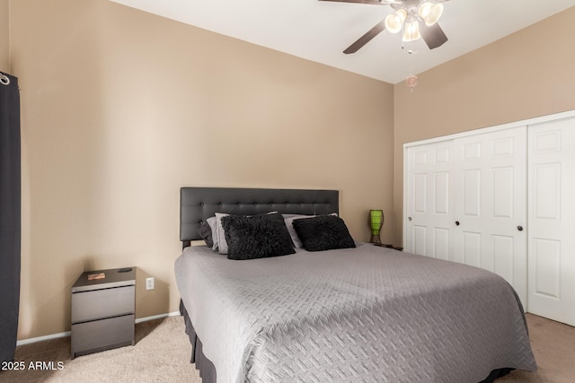 bedroom featuring ceiling fan, a closet, and carpet flooring