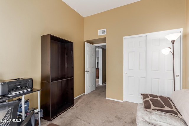 carpeted office featuring vaulted ceiling