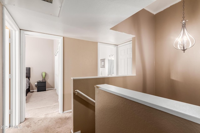 corridor with light colored carpet