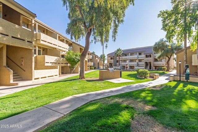 view of home's community with a lawn