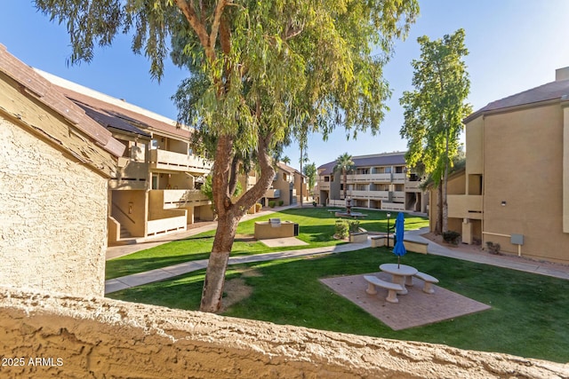 view of property's community with a yard