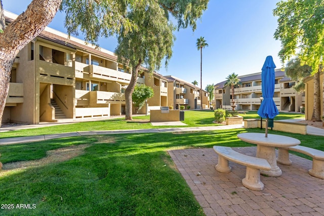 view of property's community with a lawn