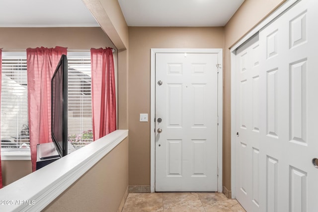 entryway with light tile patterned floors