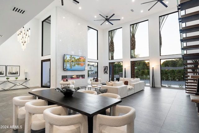 interior space with a towering ceiling and ceiling fan