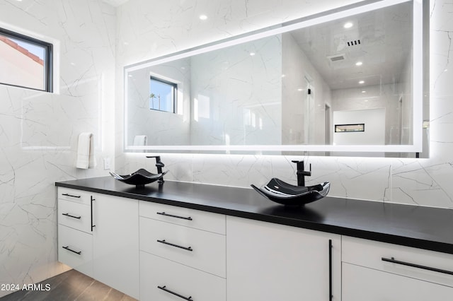 bathroom featuring vanity, tile walls, hardwood / wood-style floors, and plenty of natural light