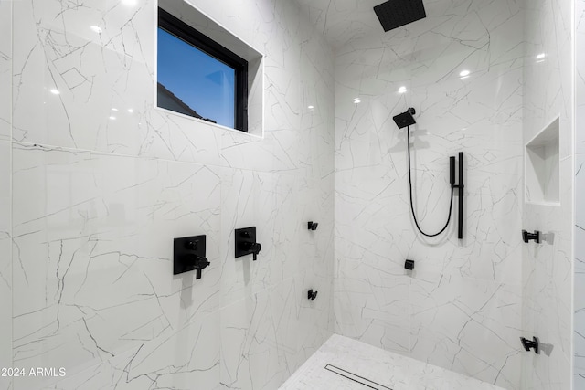 bathroom with a tile shower