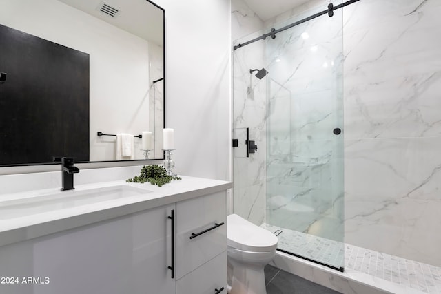 bathroom with a shower with door, vanity, and toilet