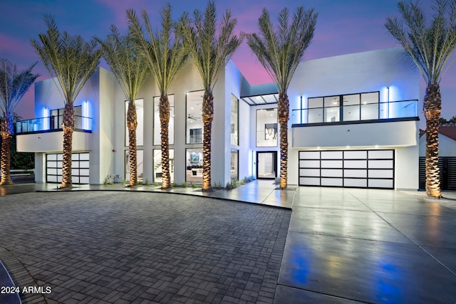 view of front of house featuring a balcony and a garage