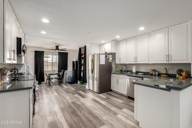 11132 W Indiana Ave, Youngtown, AZ 85363 - kitchen featuring appliances with stainless steel finishes, dark countertops, a sink, white cabinetry, and recessed lighting