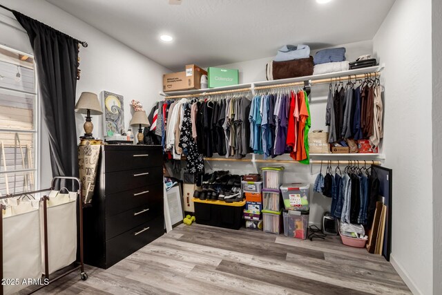 11132 W Indiana Ave, Youngtown, AZ 85363 - walk in closet featuring wood finished floors