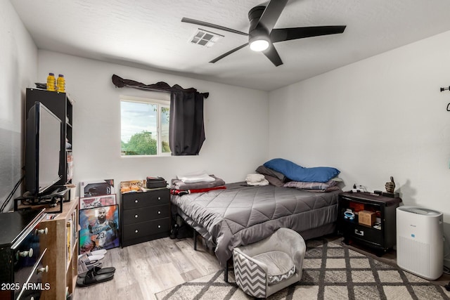 11132 W Indiana Ave, Youngtown, AZ 85363 - bedroom featuring wood finished floors and a ceiling fan