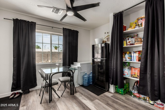 11132 W Indiana Ave, Youngtown, AZ 85363 - dining space featuring wood finished floors and ceiling fan