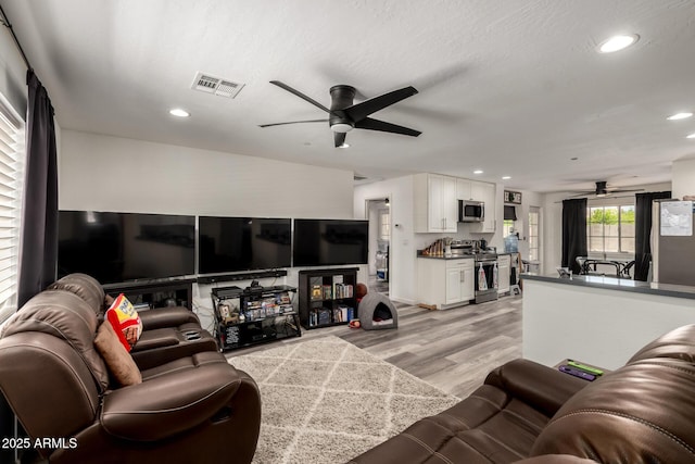 11132 W Indiana Ave, Youngtown, AZ 85363 - living room featuring ceiling fan, light wood finished floors, and recessed lighting