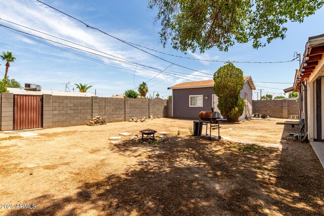 11132 W Indiana Ave, Youngtown, AZ 85363 - fenced backyard with a fire pit