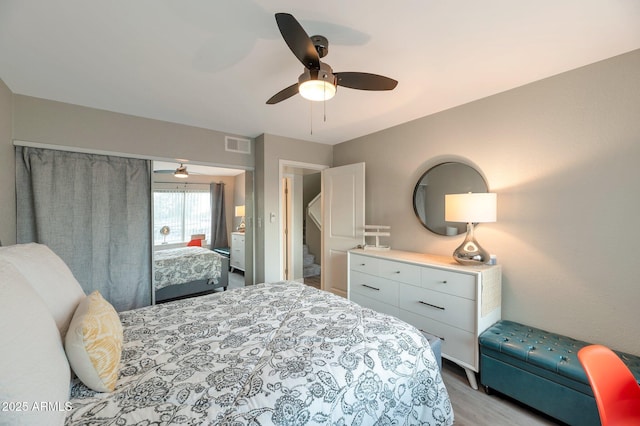 bedroom with ceiling fan and light hardwood / wood-style floors