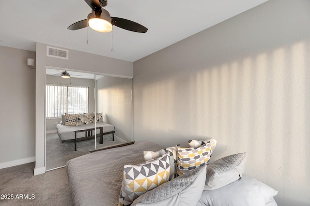 living room featuring ceiling fan and carpet