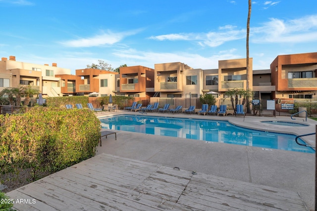 view of swimming pool featuring a patio area and a community hot tub