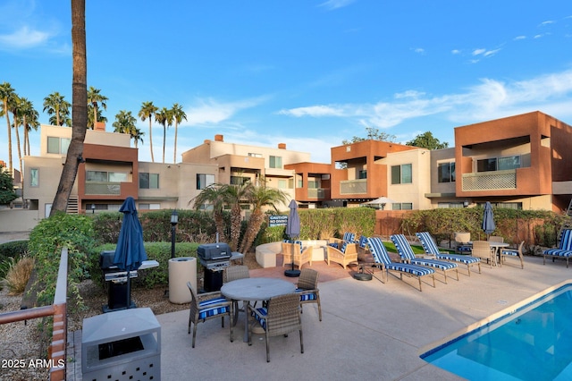 view of swimming pool with area for grilling and a patio area