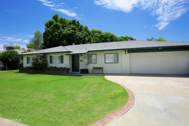 single story home with a front yard and a garage