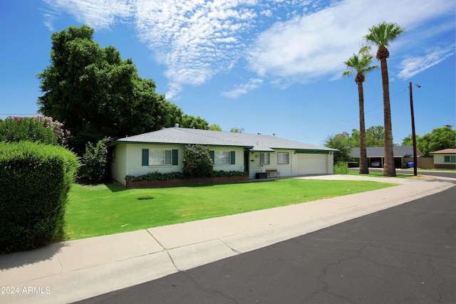 single story home featuring a front yard and a garage