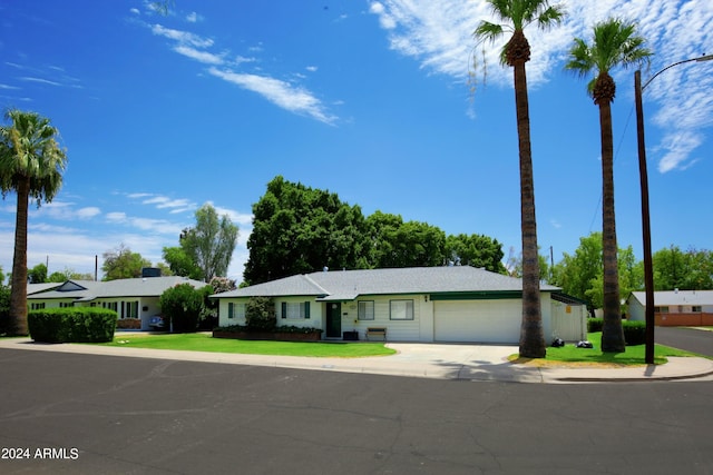 single story home with a garage and a front lawn