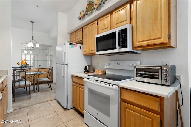 kitchen featuring pendant lighting, light tile patterned flooring, a chandelier, and white appliances