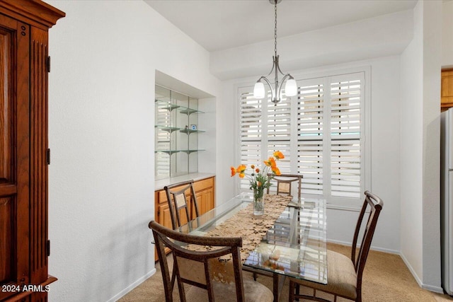 carpeted dining area featuring a notable chandelier