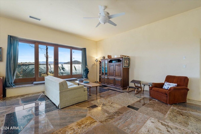 living room featuring visible vents and ceiling fan