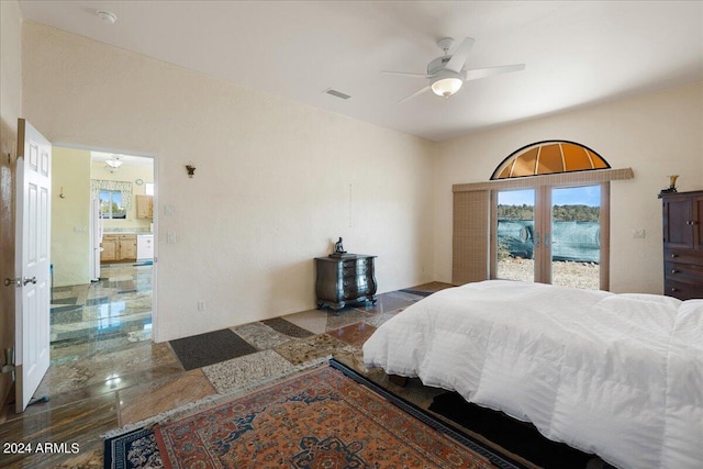 bedroom with visible vents, ceiling fan, a water view, and access to exterior