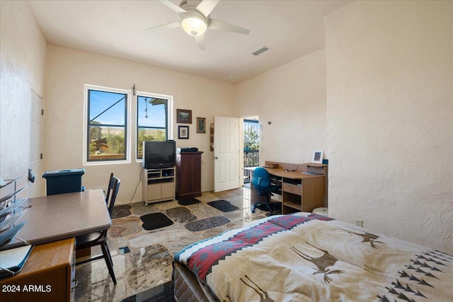 bedroom featuring visible vents, ceiling fan, and a textured wall