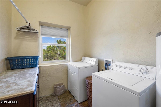 laundry room with washing machine and dryer and cabinet space