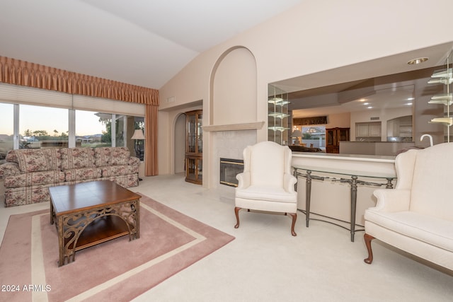 carpeted living room featuring vaulted ceiling