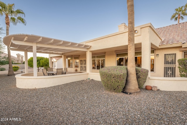 back of house with a pergola and a patio