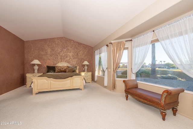 bedroom featuring light colored carpet, a water view, and vaulted ceiling