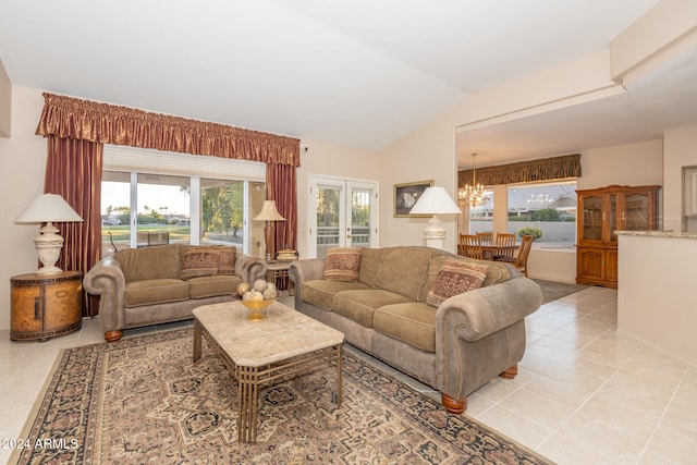 tiled living room featuring a chandelier and vaulted ceiling