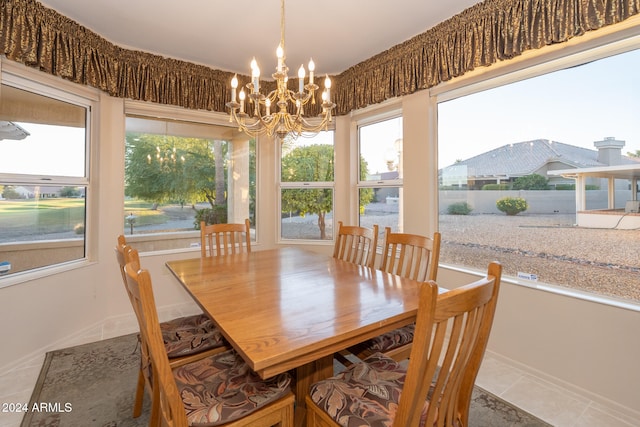 tiled dining area featuring an inviting chandelier