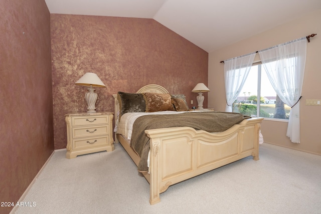 bedroom featuring light colored carpet and lofted ceiling