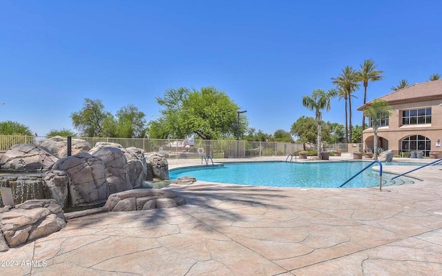 view of swimming pool with pool water feature