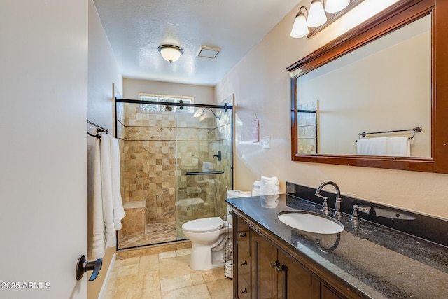 bathroom with walk in shower, vanity, toilet, and a textured ceiling