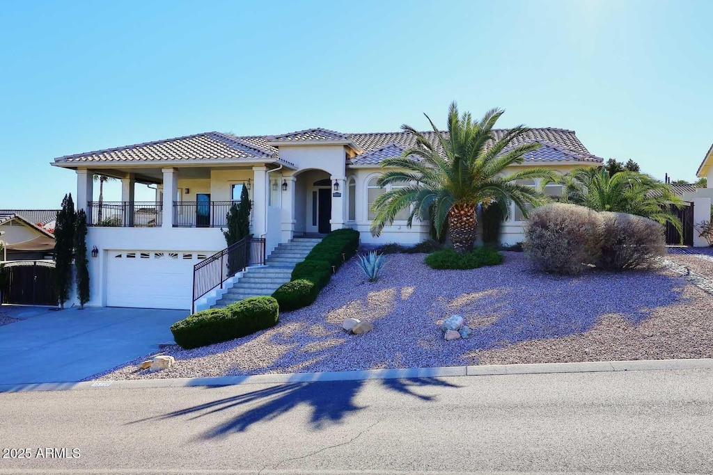 mediterranean / spanish-style house with a garage