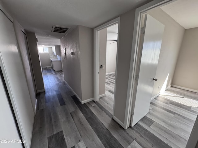 hallway with hardwood / wood-style floors