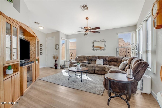 living room with ceiling fan and light hardwood / wood-style floors