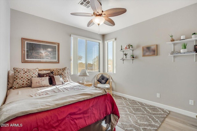 bedroom with light wood-type flooring and ceiling fan